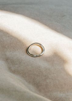 The Contour Ring is hand carved and casted in solid sterling silver. Like tracing the contours of an object with your eyes closed, the Contour Ring is based on the concept of a blind contour. A form follows, creating something that is imperfect yet feels complete. Details * Measures about 3-4mm at widest part of the ring. * Made from recycled Sterling Silver for everyday, so you don't have to be precious with it. * Sterling silver doesn't contain metal additions that can typically cause infections or allergic reactions. * The oils on your skin keeps sterling silver clean, wear often to prevent tarnishing over time. * Wear and scratches will show with time like all precious metals, but we think character is beautiful. * Handmade in Toronto, Canada to order. Allow 2-4 weeks to ship. Free shi Minimalist Hallmarked Dome Ring, Minimalist Hand Forged Engraved Promise Ring, Minimalist Hammered Signet Ring As Gift, Minimalist Hand Forged Sterling Silver Rings, Silver Brass Rings Fine Jewelry, Silver Recycled Gold Promise Ring, Minimalist Hallmarked Stackable Rings In Sterling Silver, Minimalist Hallmarked Stackable Sterling Silver Rings, Hallmarked Minimalist Sterling Silver Stackable Rings