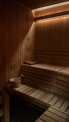 an empty sauna with wooden benches and lights