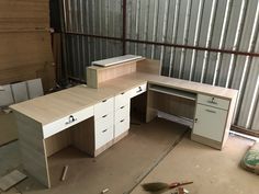 an unfinished office desk with drawers and cabinets