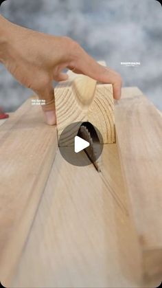 a person using a woodworking tool on a piece of wood