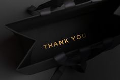 an open black box with the words thank you written on it