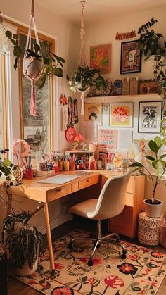 a home office with lots of plants on the desk and hanging potted plants in pots