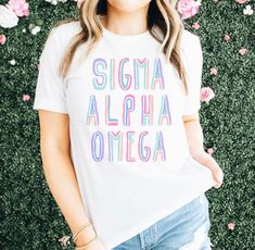 Sigma Alpha Omega Tinsel Tee. The heavyweight T-shirt is the perfect choice for lounging around the sorority house and the 100% ring spun cotton shirt is easy to care for. Printed item. This Item May Ship Separately. Sorority House, Sorority Apparel, Sorority, Cotton Shirt, Spun Cotton, The 100, Ring, T Shirt