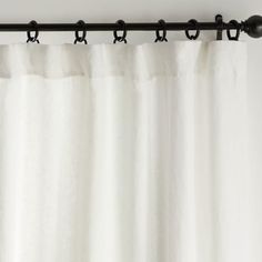 a white curtain with black hardware hanging from it's side