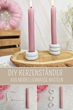 two pink candles sitting on top of a wooden table