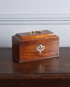 an old wooden box sitting on top of a table next to a wall and door