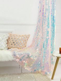 a room with a couch, rugs and a window covered in sequins