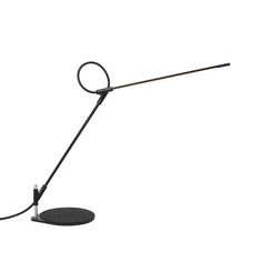 a desk lamp that is on top of a white surface with a black cord attached to it