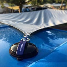 a blue car with a key chain attached to it