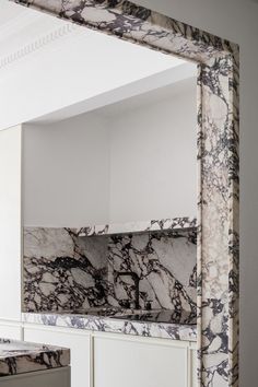 a white and black marble counter top in a kitchen