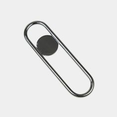 a metal paper clip with a black circle on it