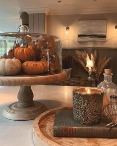 a table topped with a cake covered in pumpkins