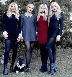 three women and a dog posing for a photo