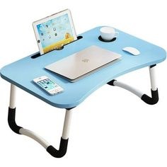 a small blue table with a laptop on top of it and a cup next to it