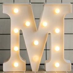 the letter m is lit up with lights