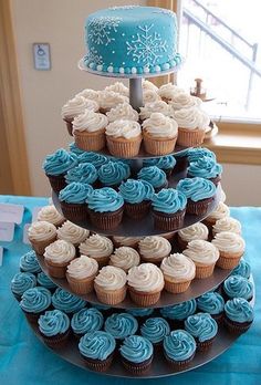 three tiered cupcake display with blue frosting