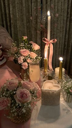 a table with candles and flowers on it