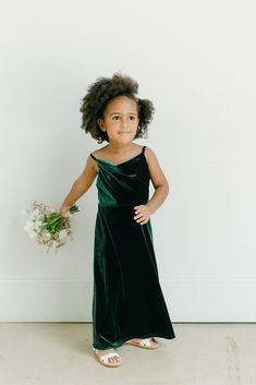 Our popular Skye Velvet dress now comes in our kids sizing and is a darling addition to match the bridal party! Kids Skye features a modest cowl neckline for more coverage and a simplistic silhouette perfect for any mini-me! Model Naveah; Size: 3T / Length: Regular, Age: 2, Height: 3'3 (measurements from 2021) FEATURES: A-line silhouette Cowl neckline Adjustable velvet spaghetti straps Side zipper Full-length double lining for extra coverage Flower Girls Dresses Dark Green, Flower Girl Green Dresses, Colorful Flower Girl Dresses, Forest Green Flower Girl Dress, Emerald Flower Girl Dress, Emerald Green Flower Girl Dress, Country Flower Girl Dresses, Country Flower Girl, Fall Flower Girl Dresses