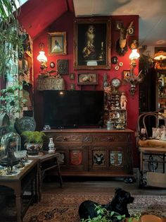 a living room filled with furniture and lots of pictures on the wall above it's tv