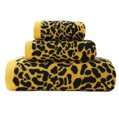 leopard print towels are stacked on top of each other, one yellow and the other black