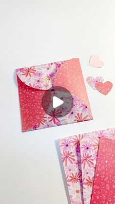 two envelopes with hearts cut out of them