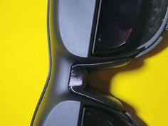 a pair of sunglasses sitting on top of a yellow surface