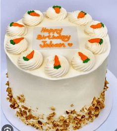 a birthday cake with white frosting and carrots