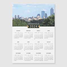 a calendar with the cityscape in the background, and trees on the side