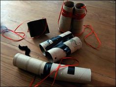 several rolls of toilet paper are on the floor next to some scissors and other items