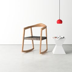 a chair and table in a room with a red light hanging from the ceiling above it