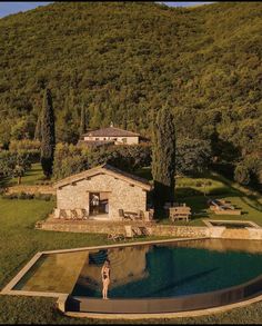 an aerial view of a house with a pool in the foreground and mountains in the background