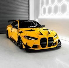 a yellow sports car parked in front of a garage door