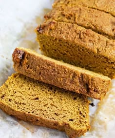 two slices of pumpkin bread sitting on top of parchment paper next to eachother