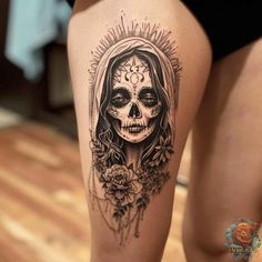 a woman's thigh with a skull tattoo on it