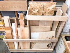 several wooden boxes stacked on top of each other in a storage area with tools and materials