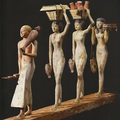 an image of some statues that are on a piece of wood and one is carrying something