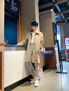 a man standing next to a counter in a building