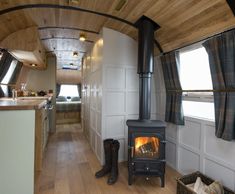 the interior of a tiny home with wood burning stove