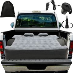 the bed in the back of a pickup truck with an air mattress on it's side