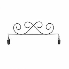 a black iron shelf with two hooks on the top and one hook attached to it