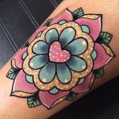 a woman's leg with a flower tattoo on it