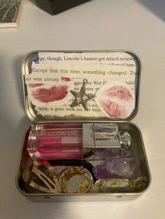 an open tin with lipstick and other items in it