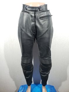 Gorgeous black leather biker pants for women. Black leather pants with light protection. The wonderful pants are made of strong, thick, soft black leather. The pants are easily fastened with a plastic zipper, which is covered by a velcro bar and a velcro belt. The pants have a front zip pocket. A notable detail of these pants is the inserts on the knees and the perforated leather on the back of the knees. The pants have plastic zips at the bottom. The trousers have a wide ribbing in the hem and a half zip for fastening the jacket. The trousers have a nice polyester lining. The pants are reliable for riding a motorcycle and will definitely make you stand out from the crowd and draw attention to you. MEASUREMENTS Pants length                                   95 cm  |  37.5 in Length inside Leather Biker Pants, Vintage Leather Pants, Riding A Motorcycle, Womens Black Pants, Biker Pants, Black Leather Pants, Womens Trousers, Pants Vintage, Lady Biker