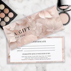 a gift certificate for charlotte king's wellness spa with makeup and eye shadow on marble background