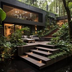 an outdoor living area with stairs leading to the upper level and plants growing on both sides