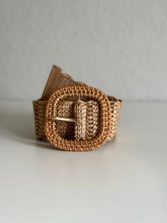 Enhance your wardrobe with our exquisite Woven Raffia Belt, featuring a stylish rattan buckle. This high-quality belt in a versatile tan color effortlessly coordinates with any outfit, making it a must-have accessory for every season. Lightweight yet durable, it provides the perfect blend of fashion and functionality. Whether you're dressing up for a special occasion or adding a chic touch to your casual attire, this belt is designed to complement your style beautifully. Embrace the natural eleg Beige Woven Belt For Vacation, Elegant Belt With Buckle Closure For Spring, Elegant Spring Belt With Buckle Closure, Adjustable Spring Belt With Buckle, Chic Brown Belt With Buckle Closure, Chic Woven Belts For Beach, Chic Woven Belt For Beach, Chic Adjustable Brown Belt, Beige Woven Belts For Spring