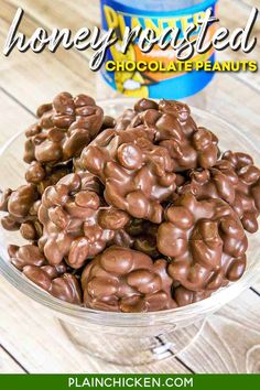 chocolate peanut clusters in a glass bowl next to a jar of honey roasted chocolate peanuts