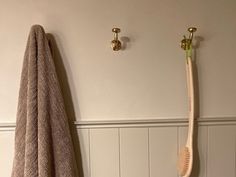 a towel rack with two toothbrushes hanging on it