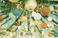 many paper lanterns hanging from the ceiling