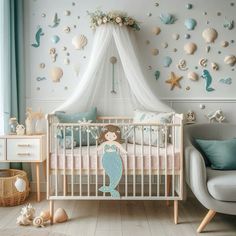 a baby's room decorated in pastel colors with sea shells and mermaid decorations